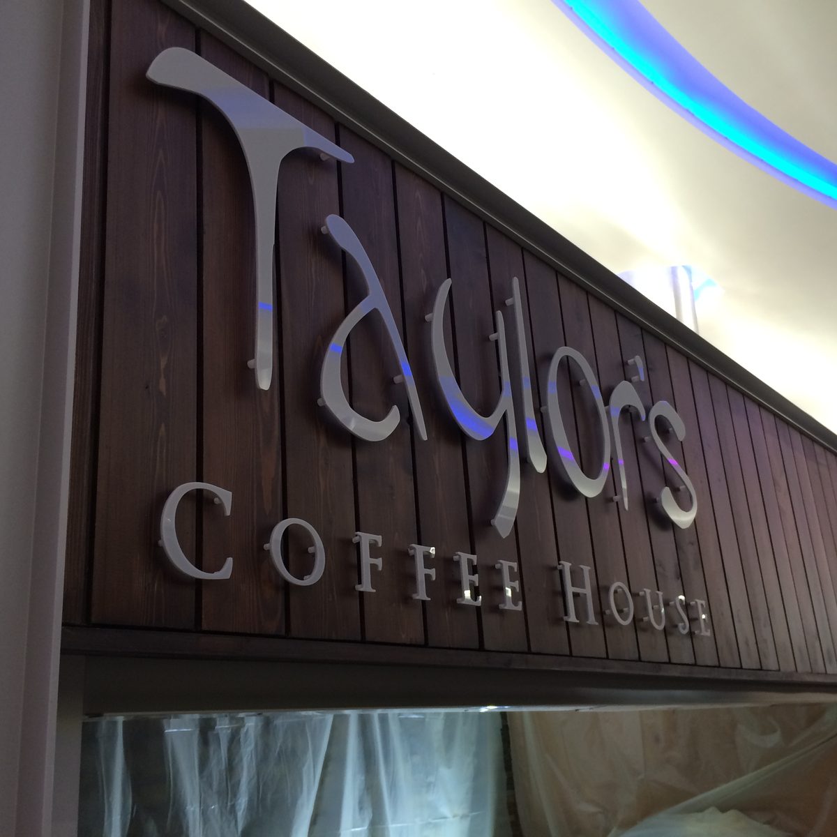 Silver 3D 'Taylor's Coffee House' lettering on a dark wood-panelled fascia