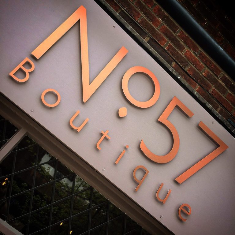 Copper 3D 'No.57 Boutique' letters on a grey fascia above a shop window