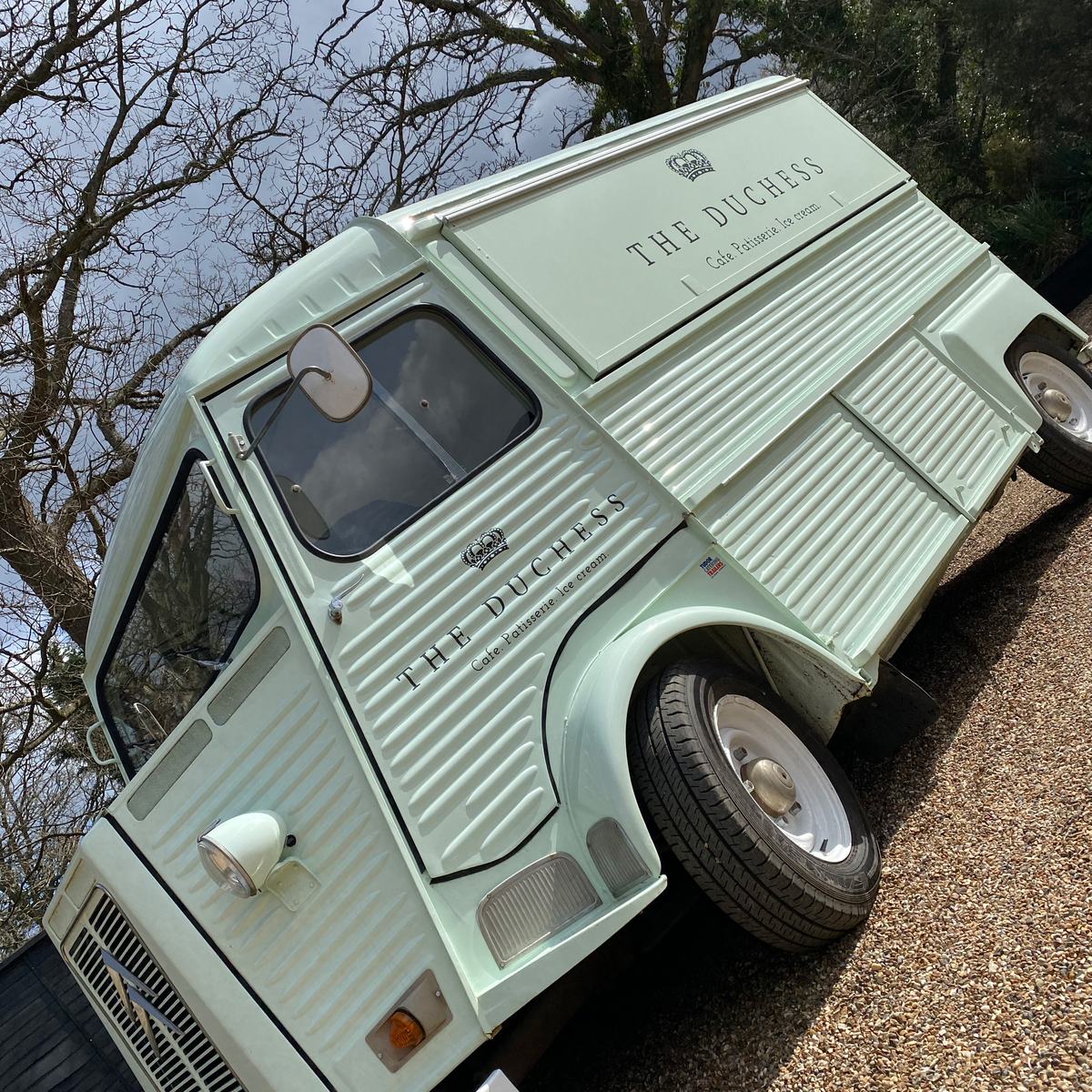Vintage mint green van with 'The Duchess' café lettering and crown logo on side panels