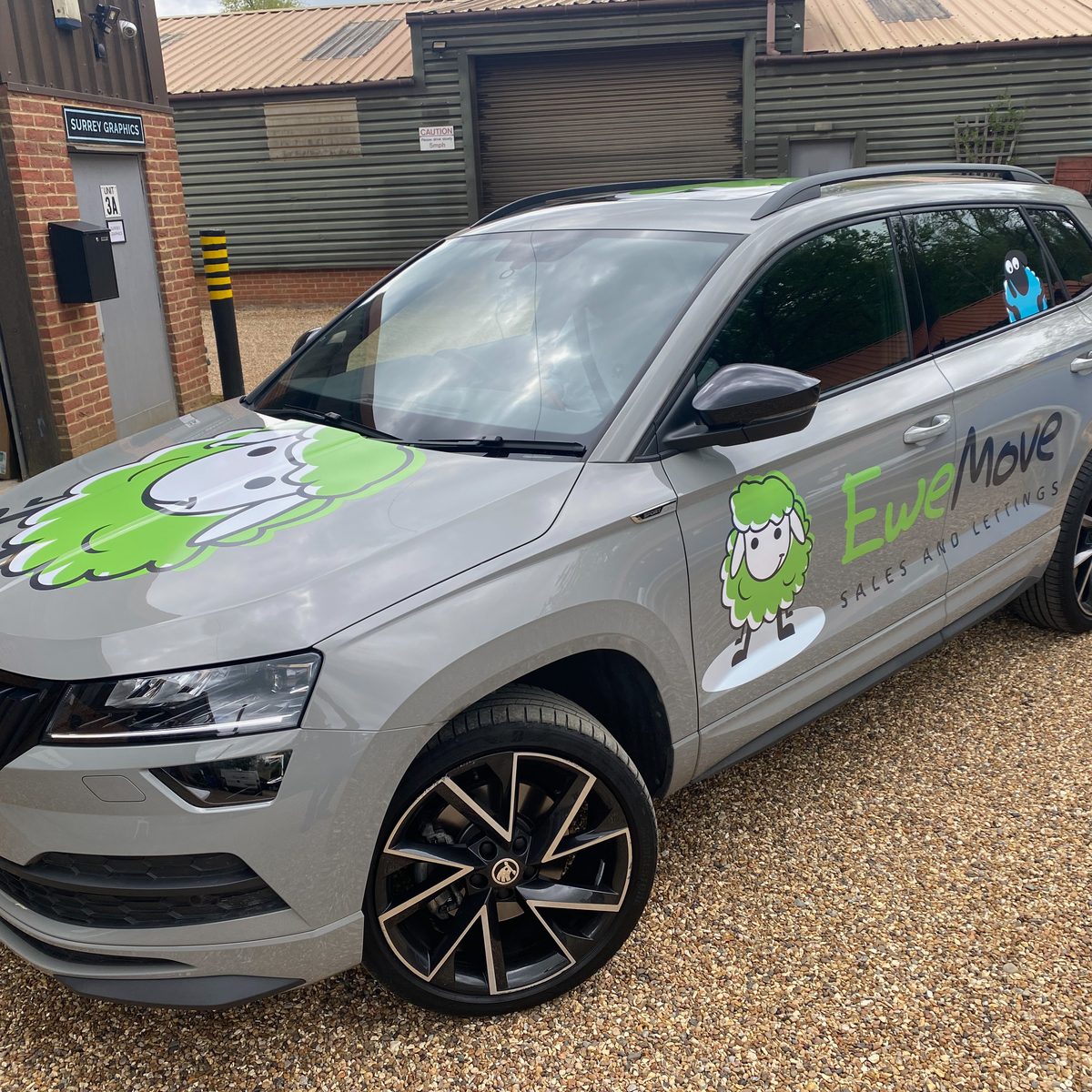 Grey SUV with green sheep graphics and EweMove Sales and Lettings lettering on door
