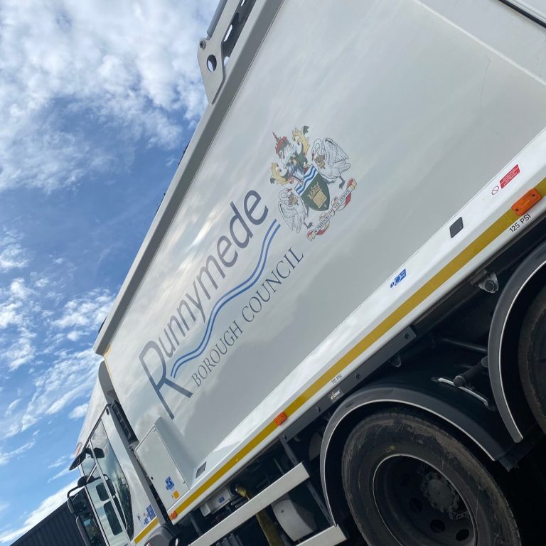 Refuse truck body with Runnymede Borough Council lettering and coat of arms
