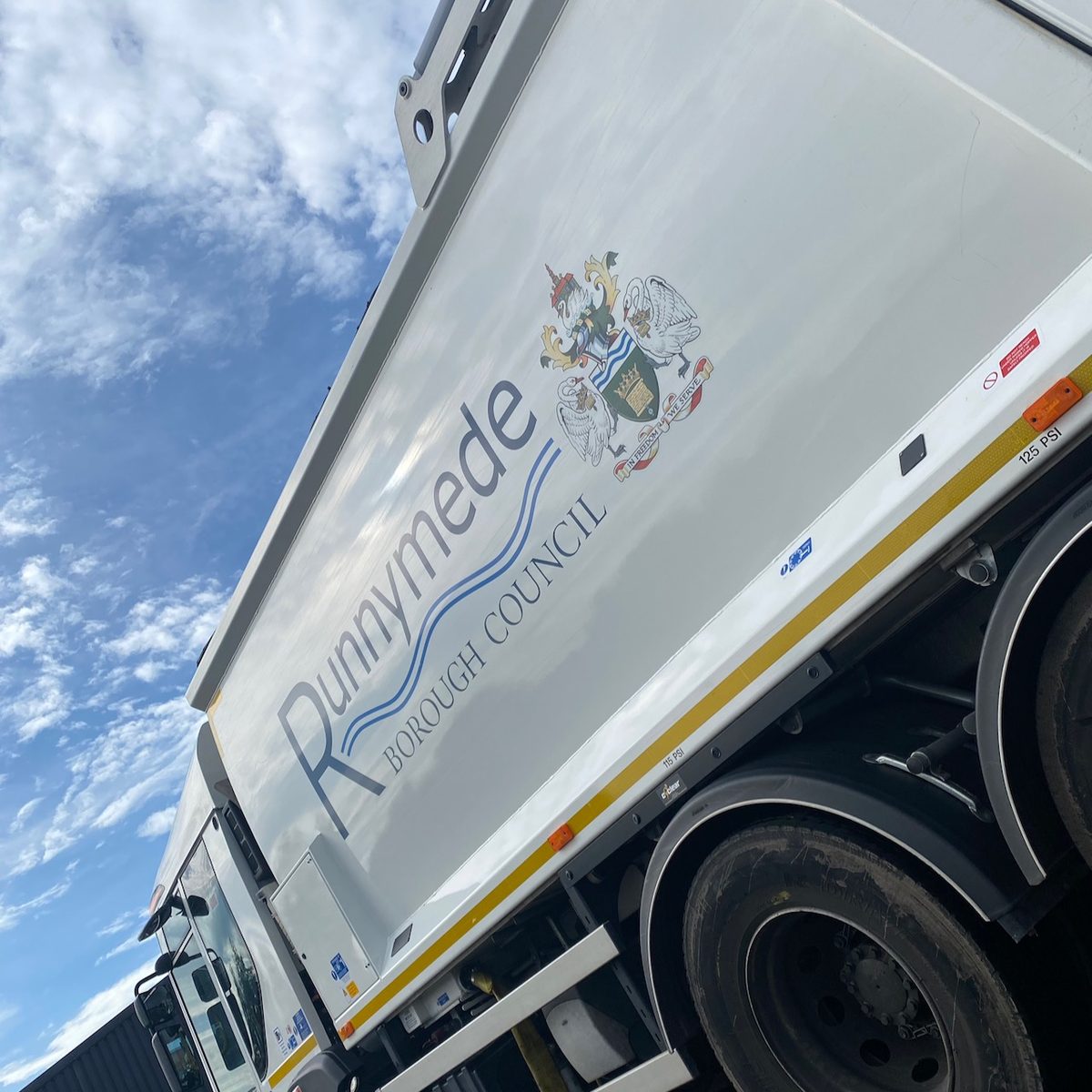 Refuse truck body with Runnymede Borough Council lettering and coat of arms