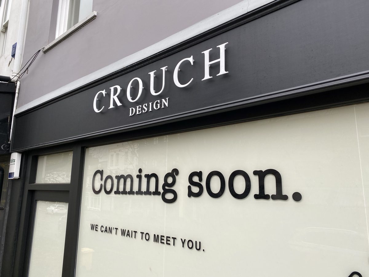 White 3D 'Crouch Design' letters on a dark grey fascia above a 'Coming soon' shop window