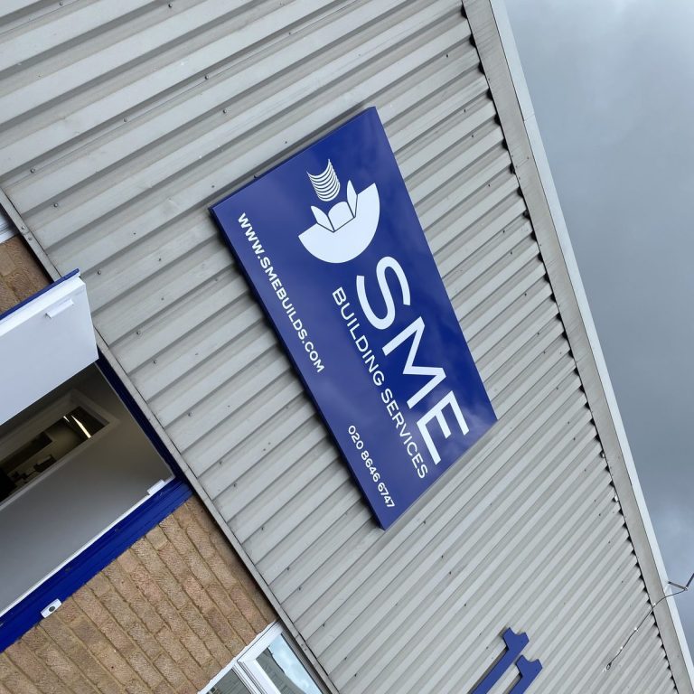 Blue SME Building Services aluminium composite sign on a grey clad industrial unit