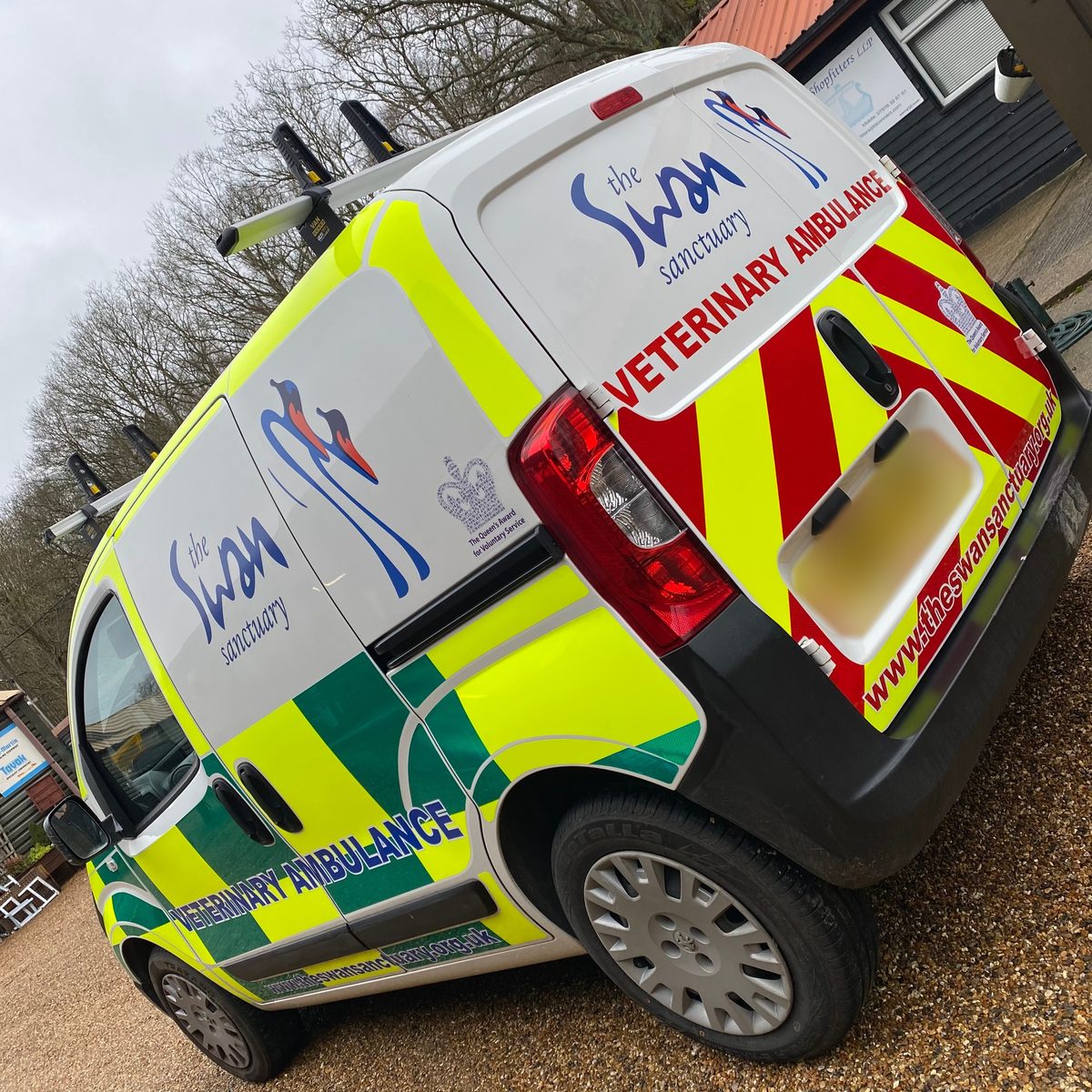 White Swan Sanctuary veterinary ambulance van with red and yellow Chapter 8 chevrons on the rear doors