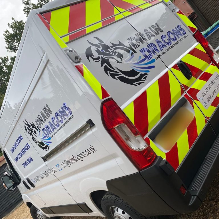 White Drain Dragons van with red and yellow Chapter 8 chevrons on the rear doors and dragon logo graphics