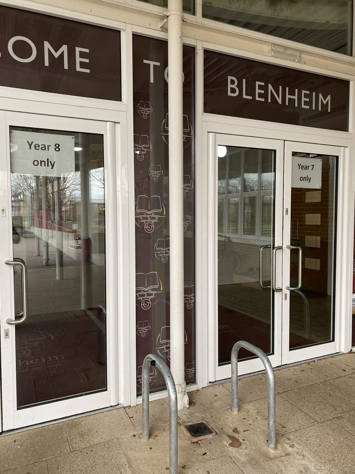Blenheim school entrance doors with burgundy 'Welcome to Blenheim' window graphics