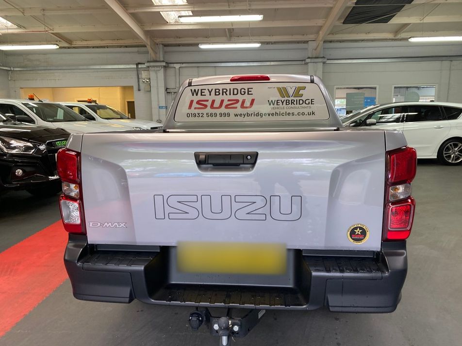 Silver Isuzu D-Max pickup with Weybridge Isuzu rear window graphic and phone number