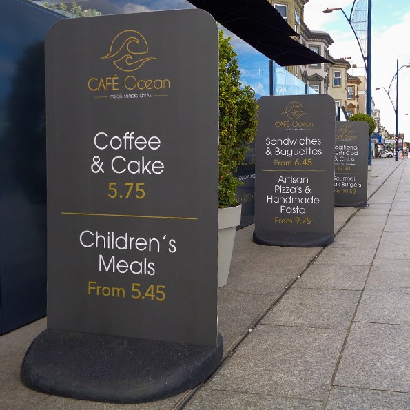 Three Ecoflex pavement signs outside a restaurant