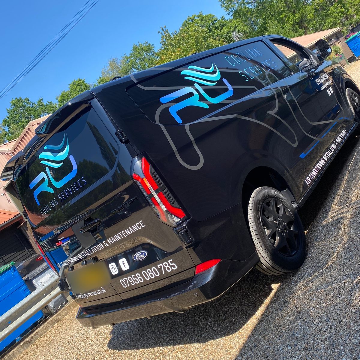 Black Ford Transit Custom with blue wave logo, Cooling Services and air conditioning installation lettering