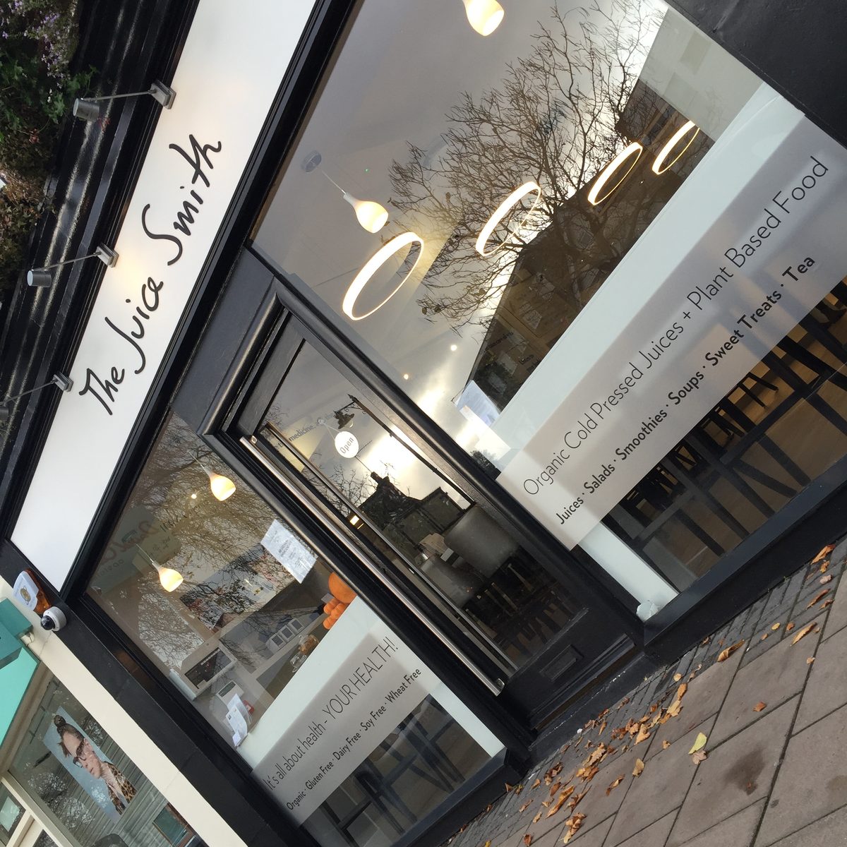The Juice Smith shopfront with frosted window bands listing juices, salads, smoothies and plant-based food